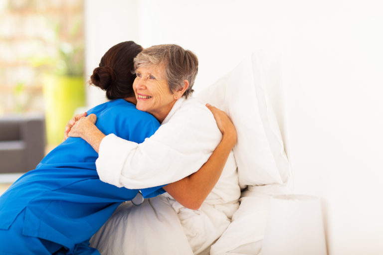 Nurse hugging patient